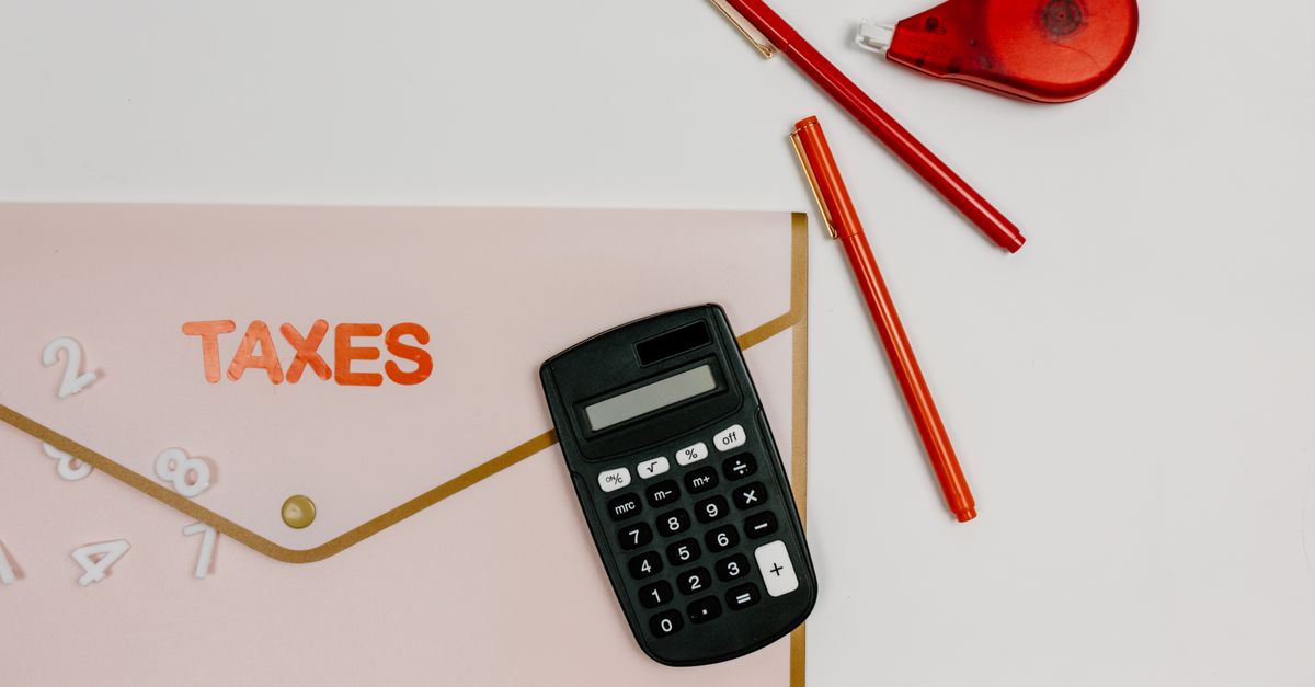 Calculator and tax documents on a dealer's desk